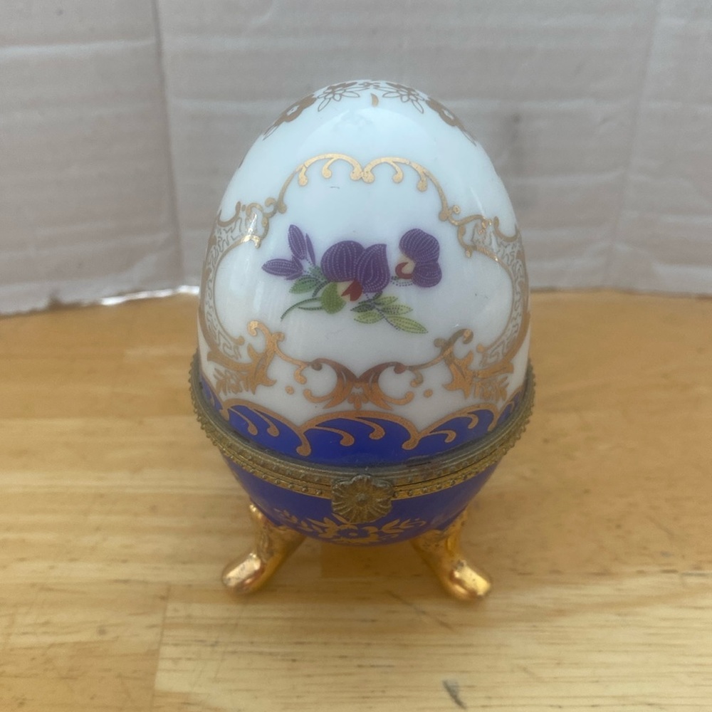 Vintage hinged porcelain egg trinket box. About 4 in Gold and blue